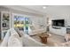Open-concept living room with neutral tones, comfortable seating, and serene outdoor views at 4947 Green Dolphin Way, Kiawah Island, SC 29455