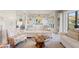 Bright living room with white sofa, decorative pillows, and a unique wood-based coffee table at 4947 Green Dolphin Way, Kiawah Island, SC 29455