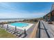 Beautiful pool next to the ocean with many lounge chairs available for sunbathing, and an indoor outdoor structure at 4947 Green Dolphin Way, Kiawah Island, SC 29455