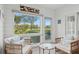 Inviting sunroom featuring wicker seating and scenic views of the lush green landscape and golf course at 4947 Green Dolphin Way, Kiawah Island, SC 29455