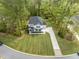 Aerial view of a two-story home with a long drive, attached garage and grassy front lawn at 5005 Buckland Trl, Ridgeville, SC 29472