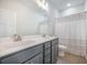Modern bathroom with double vanity, white countertops, and stylish gray cabinets at 5005 Buckland Trl, Ridgeville, SC 29472