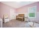 Charming Bedroom with pink walls, white wainscoting, and a wooden crib at 5005 Buckland Trl, Ridgeville, SC 29472