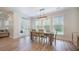 Dining room featuring hardwood floors, a modern light fixture, and a view of the backyard through large windows at 5005 Buckland Trl, Ridgeville, SC 29472