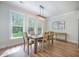 Dining room with hardwood floors, a modern chandelier, and large windows offering backyard views at 5005 Buckland Trl, Ridgeville, SC 29472