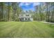 Inviting two-story home with black shutters, lush lawn, and attached two-car garage at 5005 Buckland Trl, Ridgeville, SC 29472