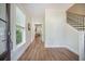 Elegant foyer with wood floors, staircase, and view into the living area at 5005 Buckland Trl, Ridgeville, SC 29472