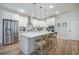 Modern kitchen featuring white cabinets, stainless steel appliances, an island with seating, and hardwood flooring at 5005 Buckland Trl, Ridgeville, SC 29472