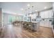Open kitchen featuring a large island, barstool seating and an adjacent dining area at 5005 Buckland Trl, Ridgeville, SC 29472