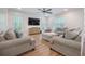 Bright living room with hardwood floors, a large TV, board and batten accent wall, and comfortable neutral furnishings at 5005 Buckland Trl, Ridgeville, SC 29472