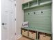 Charming mudroom with built-in bench, storage, and stylish sage green accents at 5005 Buckland Trl, Ridgeville, SC 29472