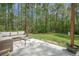 This patio offers a quiet outdoor space with comfortable seating, a table, and lush greenery in the spacious backyard at 5005 Buckland Trl, Ridgeville, SC 29472