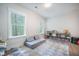 Spacious playroom with natural light, a cozy gray convertible sofa, and ample storage at 5005 Buckland Trl, Ridgeville, SC 29472
