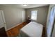 Bright bedroom with neutral colors, hardwood floors, and a large window for natural light at 502 May St, Saint George, SC 29477