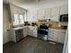 Functional kitchen with ample cabinet space, stainless steel appliances, and a well-lit design at 502 May St, Saint George, SC 29477