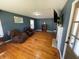 Inviting living room featuring beautiful hardwood floors, a decorative fireplace, and ample natural light at 502 May St, Saint George, SC 29477