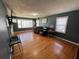 Bright living room featuring large windows, hardwood floors, and comfortable seating area, ideal for relaxation at 502 May St, Saint George, SC 29477
