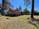 Single-story brick home with a large yard perfect for outdoor activities and enjoying the surrounding scenery at 502 May St, Saint George, SC 29477