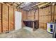 Unfinished basement area with wood walls and water heater, ready for customization and ample storage at 503 W Carolina Ave, Summerville, SC 29483