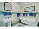 Charming bathroom features a clawfoot tub, pedestal sink, and well-placed towel bars at 503 W Carolina Ave, Summerville, SC 29483