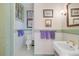 Charming bathroom with classic fixtures, decorative art and a stained glass window, adding character to the space at 503 W Carolina Ave, Summerville, SC 29483