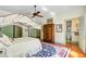 A large bedroom features a beautiful four-poster bed and an ensuite bathroom behind a sage-green door at 503 W Carolina Ave, Summerville, SC 29483