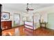 Bright bedroom with a beautiful canopy bed, hardwood floors and a sage colored entry door at 503 W Carolina Ave, Summerville, SC 29483