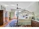 Bedroom with four poster bed, ceiling fan, hardwood floors, and ample natural light from window at 503 W Carolina Ave, Summerville, SC 29483
