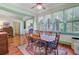 Spacious dining room with large window, hardwood floors, and view into the living room at 503 W Carolina Ave, Summerville, SC 29483