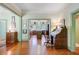 Spacious entryway with gleaming hardwood floors and open view to the kitchen at 503 W Carolina Ave, Summerville, SC 29483
