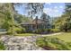 Beautiful home exterior showcases a manicured lawn, lush landscaping, and a welcoming driveway at 503 W Carolina Ave, Summerville, SC 29483