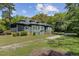 Inviting exterior of a two-story home with a screened porch and a well-maintained green lawn at 503 W Carolina Ave, Summerville, SC 29483