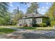 Charming exterior view of a gray home with a manicured lawn, showcasing its inviting curb appeal at 503 W Carolina Ave, Summerville, SC 29483