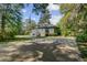 Attractive exterior view of a gray home with a manicured lawn, framed by mature trees at 503 W Carolina Ave, Summerville, SC 29483