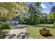 Detached garage with three bays and a paved driveway surrounded by lush greenery at 503 W Carolina Ave, Summerville, SC 29483