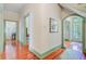 Hallway view of the doors leading to other parts of the home, showcasing the hardwood floors and trim at 503 W Carolina Ave, Summerville, SC 29483