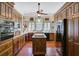 Traditional kitchen with hardwood floors, custom cabinets, stainless appliances, and functional center island at 503 W Carolina Ave, Summerville, SC 29483