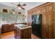 Eat-in kitchen featuring stainless appliances, hardwood cabinets, central island and a view to the backyard at 503 W Carolina Ave, Summerville, SC 29483