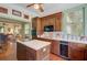 Bright eat-in kitchen with hardwood cabinets, central island, view to living room, and stainless dishwasher at 503 W Carolina Ave, Summerville, SC 29483