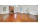 Spacious living room with hardwood floors and a charming brick fireplace, flooded with natural light at 503 W Carolina Ave, Summerville, SC 29483