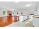 Open concept living space with beautiful hardwood floors, brick fireplace, and direct access to the kitchen at 503 W Carolina Ave, Summerville, SC 29483