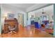 Comfortable living room with fireplace, hardwood floors, ceiling fan, and opening leading to another room at 503 W Carolina Ave, Summerville, SC 29483