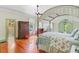 A spacious main bedroom boasts a canopy bed, hardwood floors, and a connected ensuite bathroom at 503 W Carolina Ave, Summerville, SC 29483