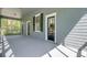 Covered porch with painted floor, features multiple access doors and a hammock in the background at 503 W Carolina Ave, Summerville, SC 29483