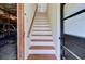 Staircase leading upstairs with wooden treads, connecting to additional living space and garage access at 503 W Carolina Ave, Summerville, SC 29483