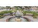 Town Square with lush greenery, walking path, benches, planters, and water fountain at 503 W Carolina Ave, Summerville, SC 29483