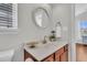 A charming half bathroom with a round mirror and updated vanity at 5033 Carrington Ct, Summerville, SC 29485