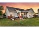 Beautiful home exterior with a spacious yard, deck, screened porch, and landscaped garden at 5033 Carrington Ct, Summerville, SC 29485