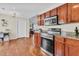 A charming kitchen featuring granite countertops, stainless steel appliances, and wood floors at 5033 Carrington Ct, Summerville, SC 29485