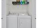 Well-equipped laundry room with modern washer and dryer units and organized shelving at 5033 Carrington Ct, Summerville, SC 29485